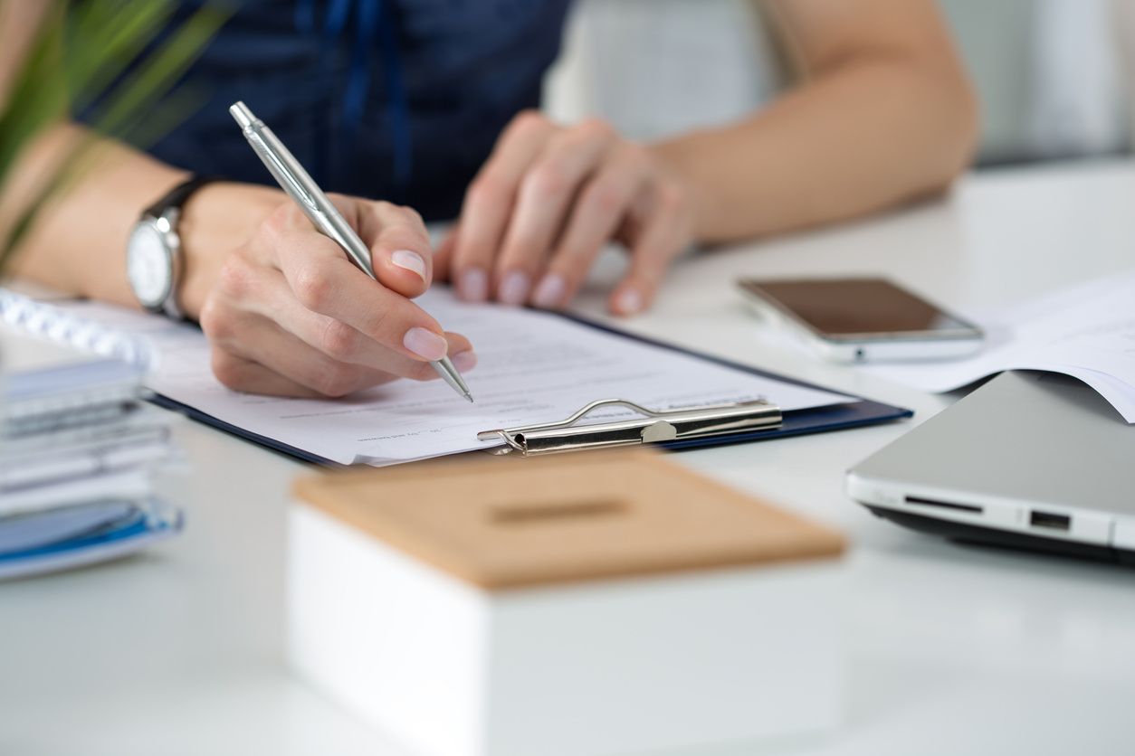 person writing on paper